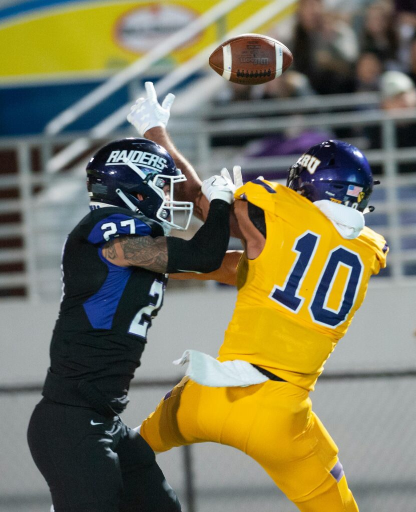 Exciting capture of two football players in a close action moment during a game.